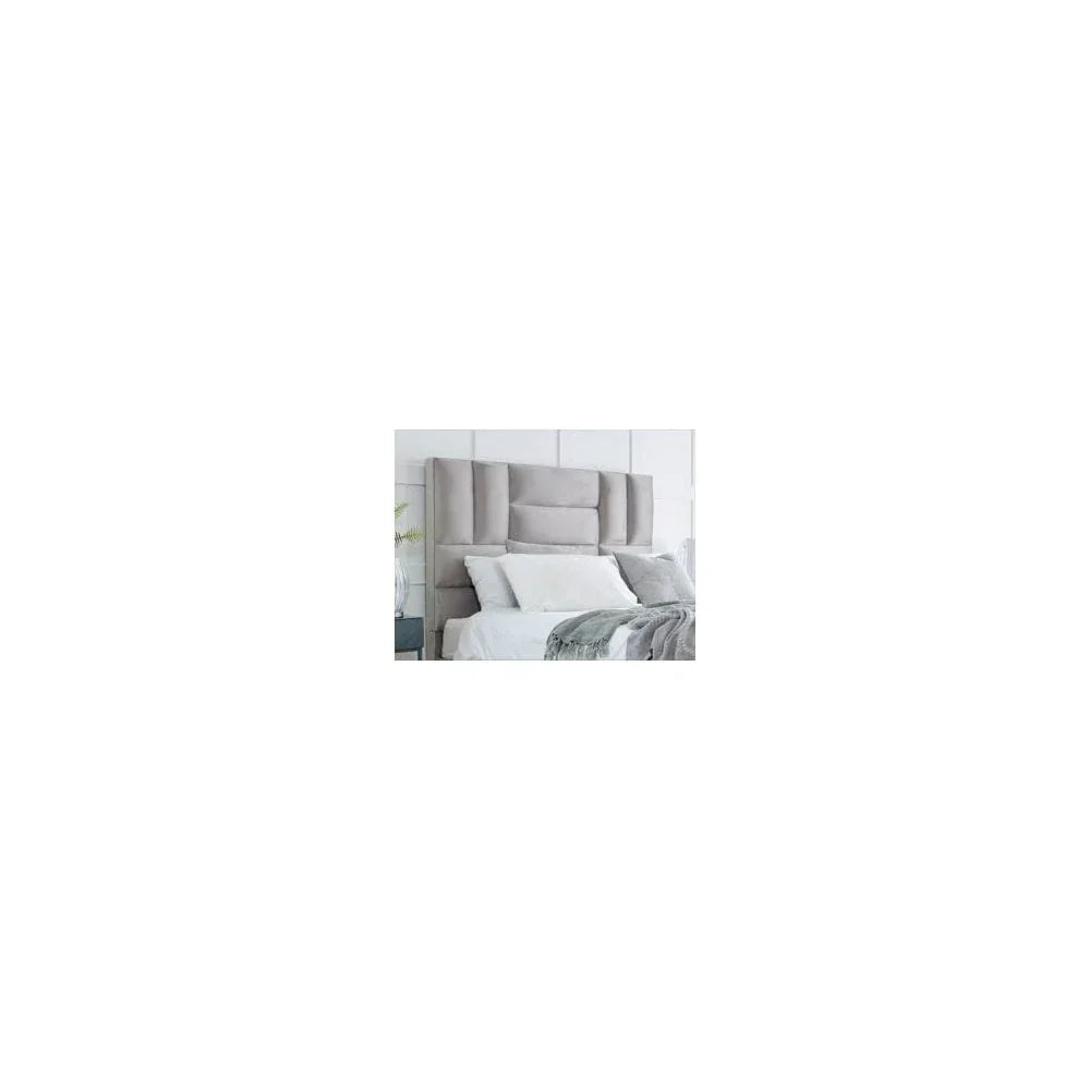 Grey upholstered bed with tall padded headboard and white bedding in modern bedroom
