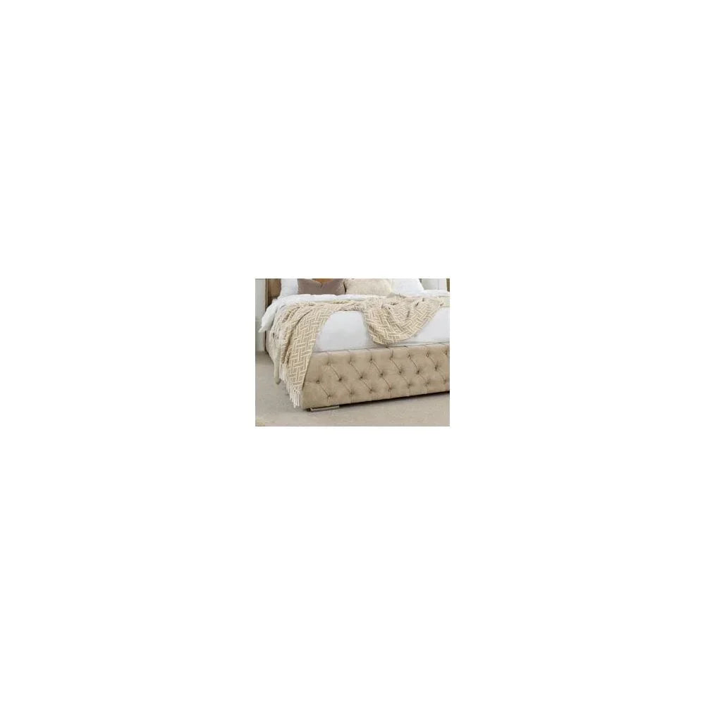 Beige fabric upholstered bed frame with tufted detailing and cream throw blanket