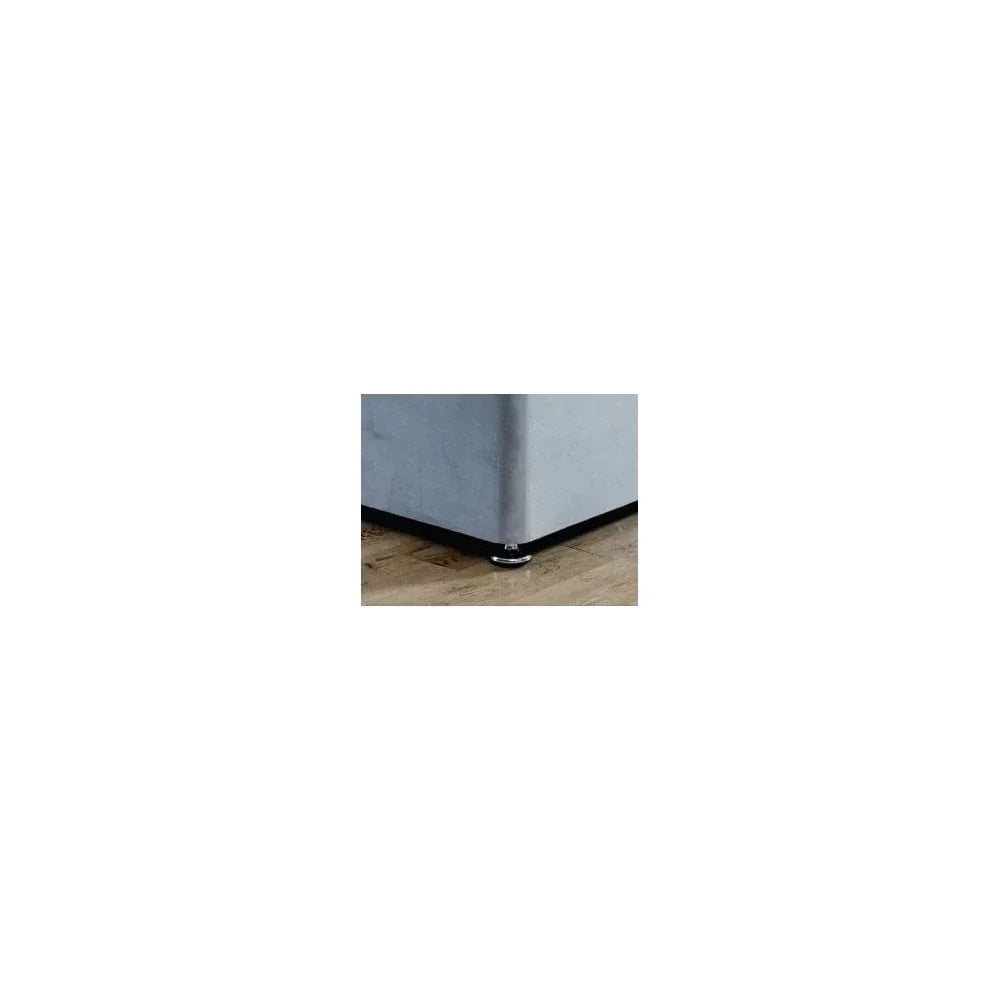 Grey sofa corner with chrome foot on wooden floor