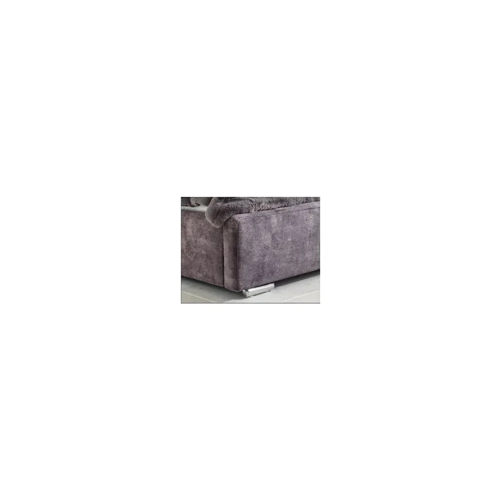 Close view of grey fabric sofa armrest with metal leg on tiled floor