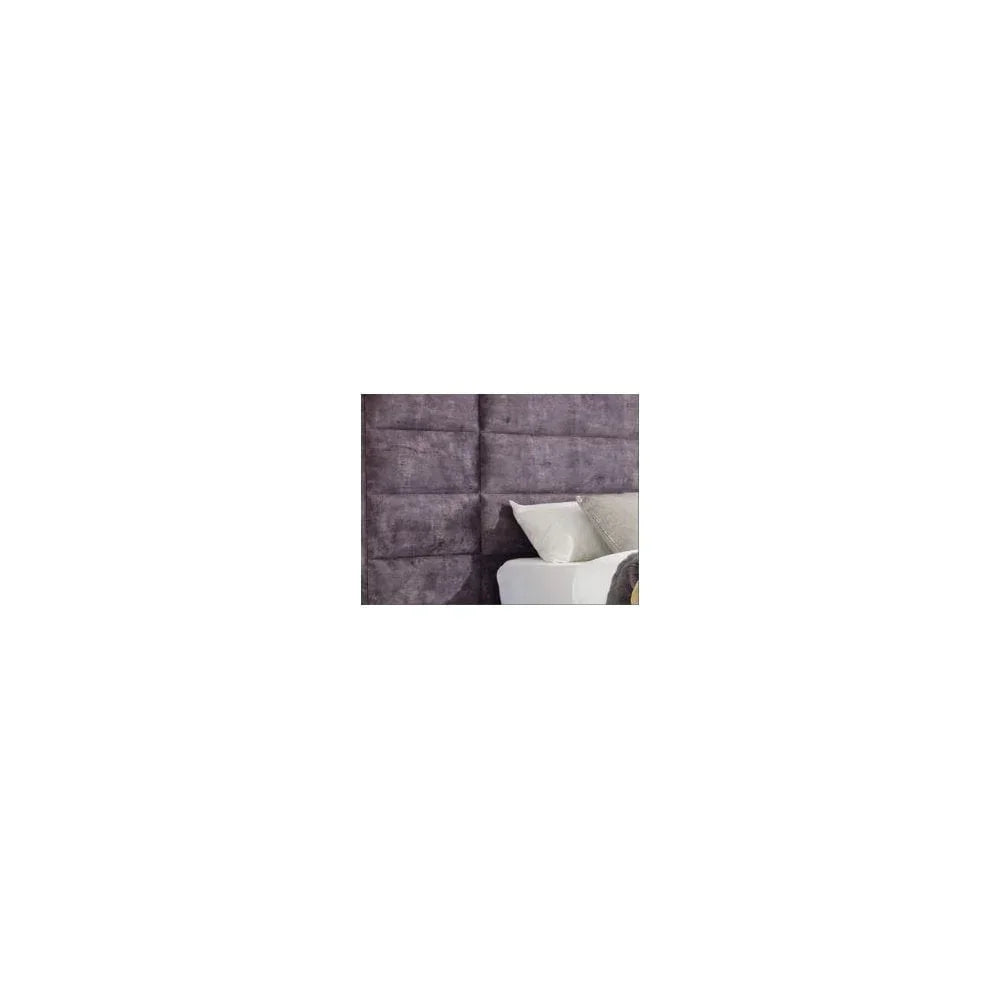 Plush purple fabric headboard with panel design and white pillows on bed