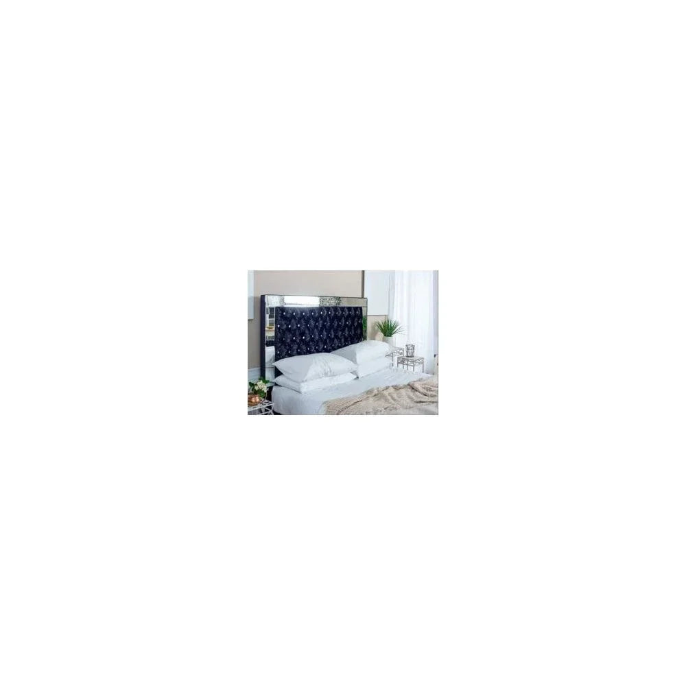 Black velvet bed with mirrored headboard and button-tufted design in modern bedroom