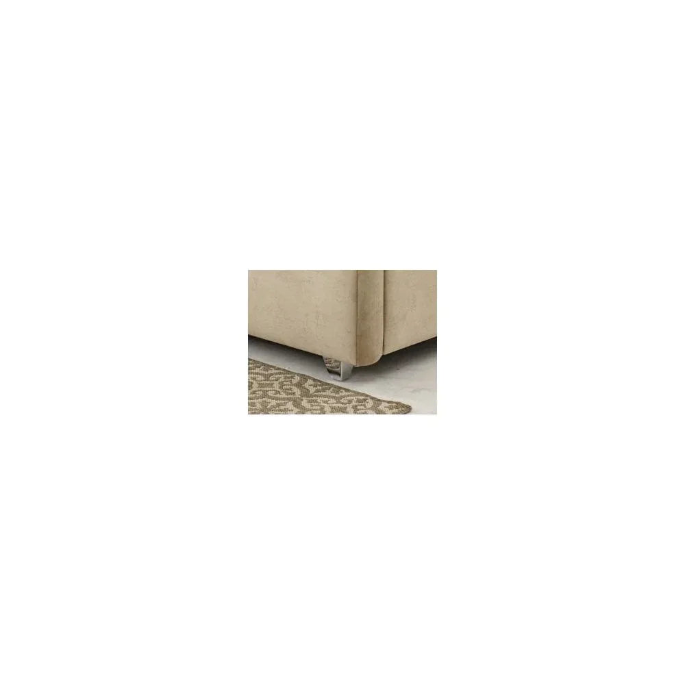 Beige fabric sofa corner with chrome leg on patterned rug and marble floor