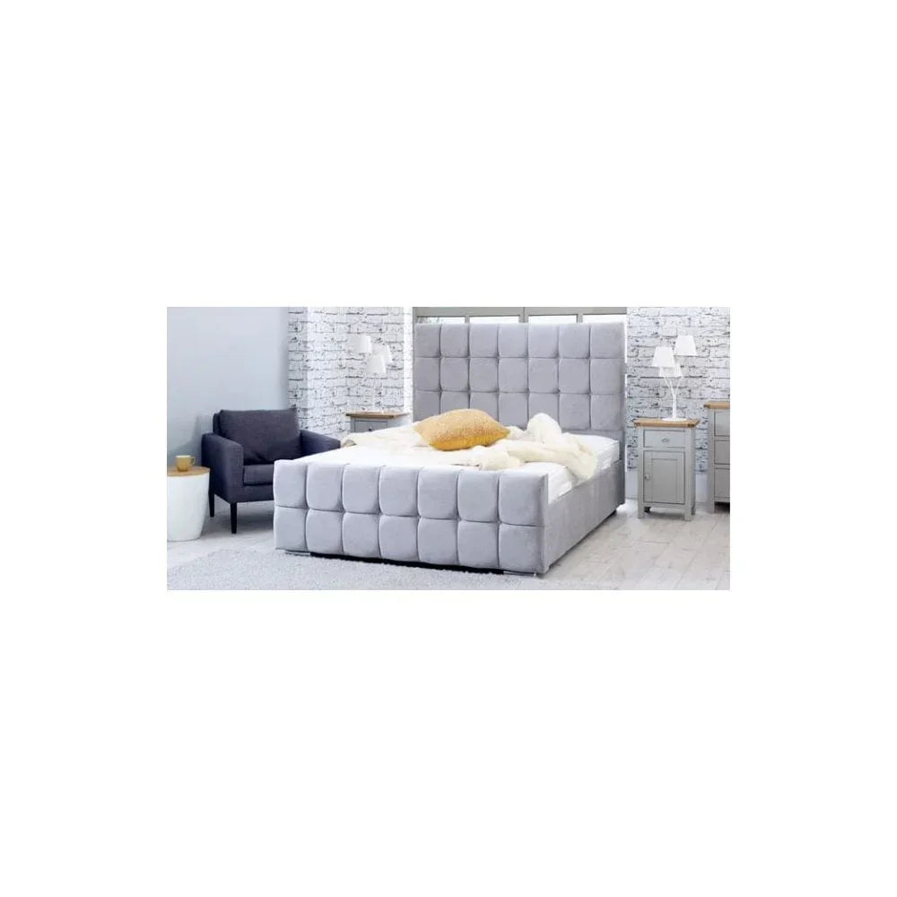 Grey upholstered bed with square tufted headboard in modern bedroom setting