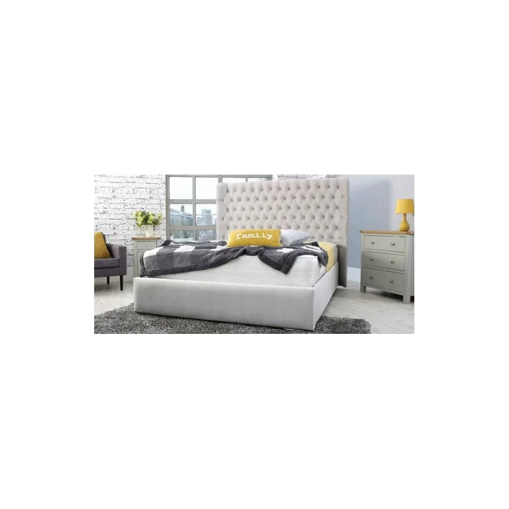 Upholstered bed frame with tall tufted headboard in modern bedroom with grey rug and nightstand