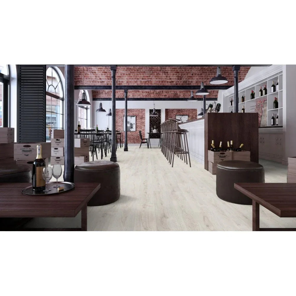 Light oak effect laminate flooring in modern bar with dark wood tables and stools