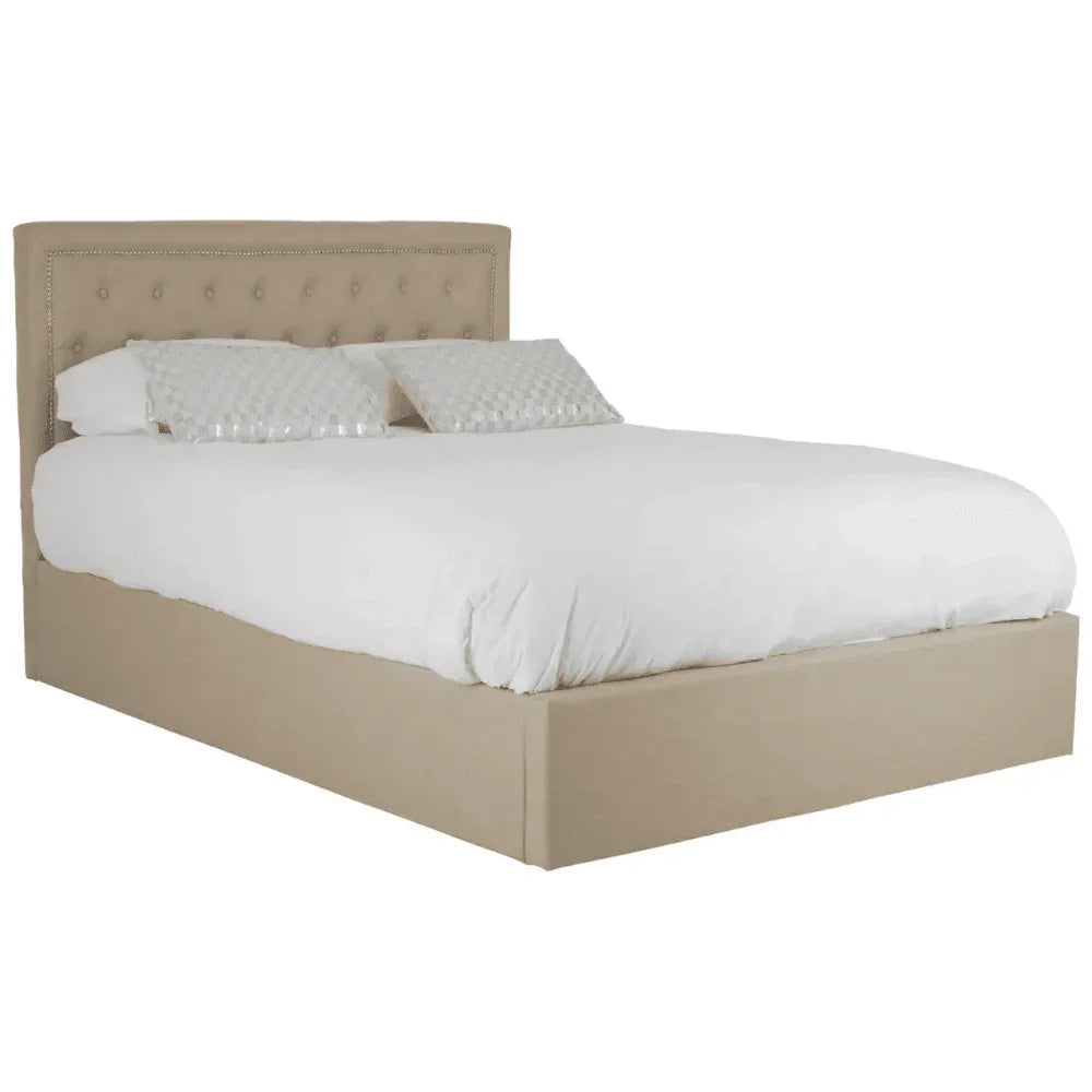 Beige upholstered bed frame with tufted headboard and white bedding