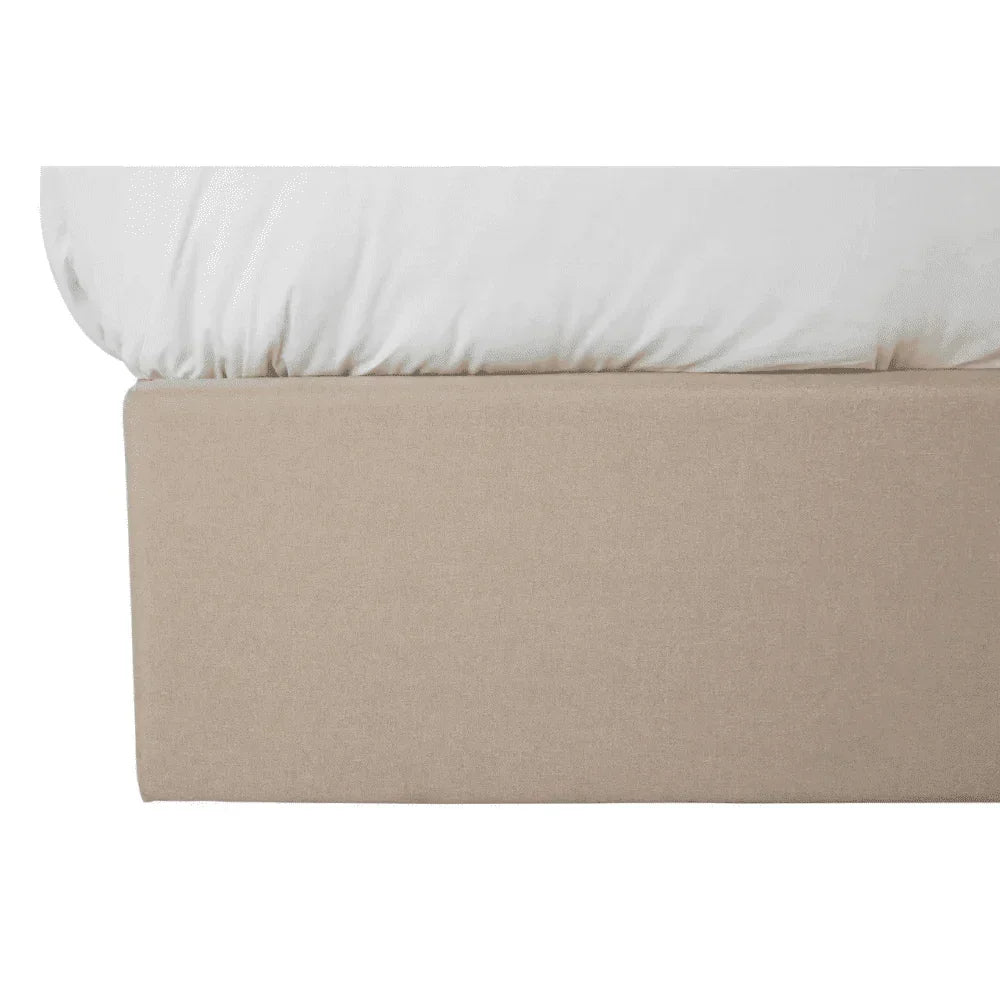 Beige fabric bed base with white mattress corner detail