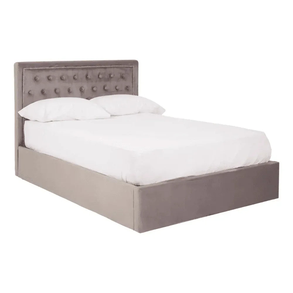 Grey upholstered bed frame with buttoned headboard shown with white bedding