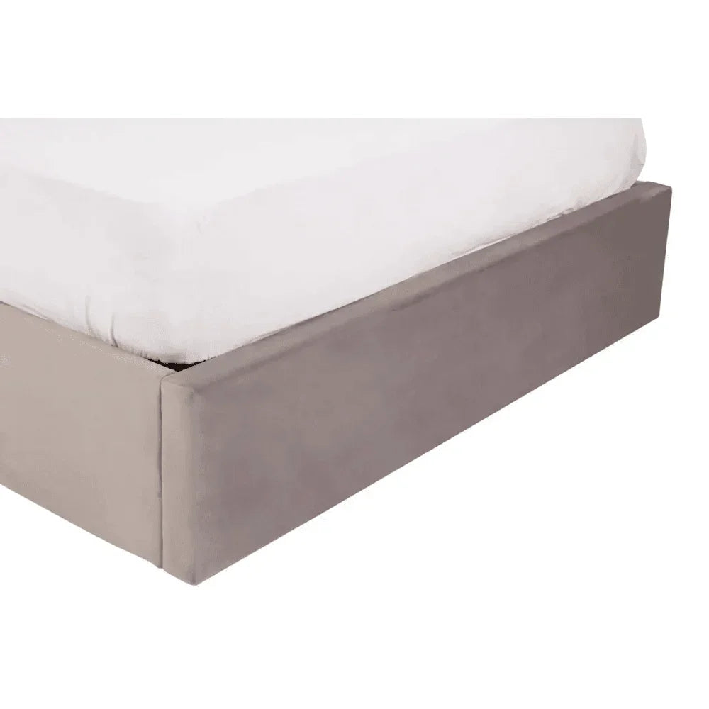 Grey bed base with clean fabric finish and white mattress corner close up