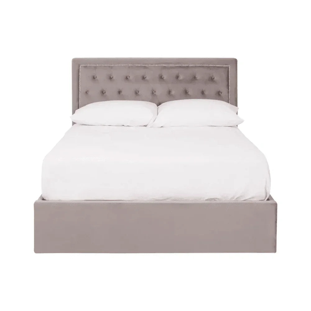 Grey upholstered double bed with button tufted headboard and white bedding, front view