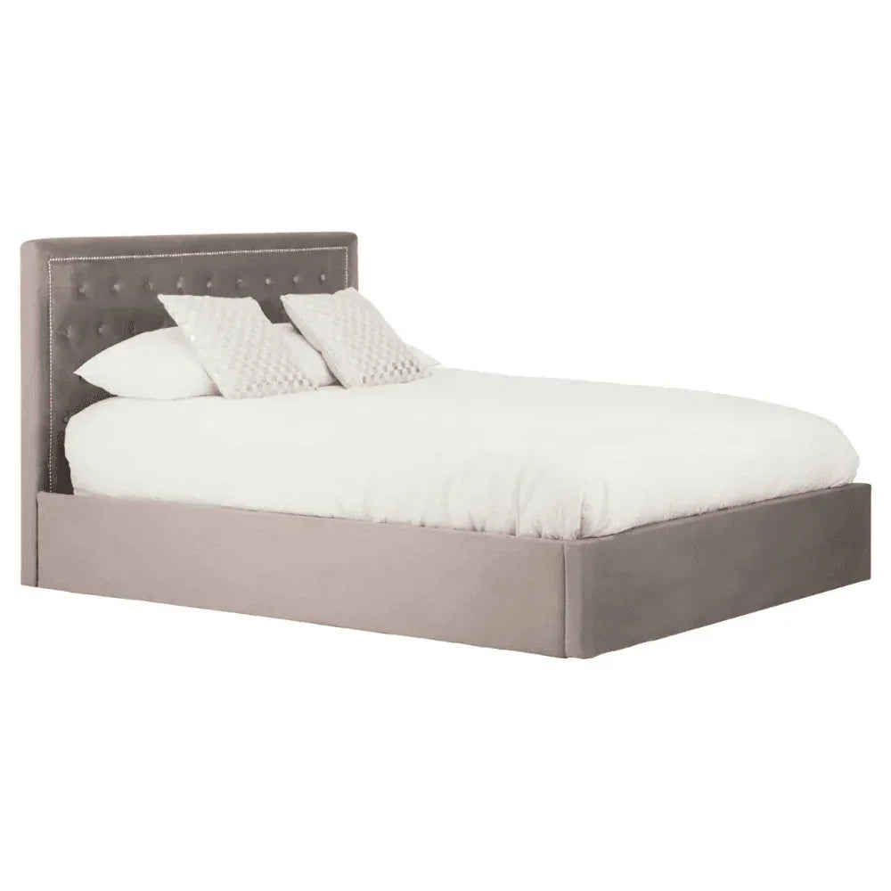 Grey upholstered bed frame with tufted headboard and white bedding
