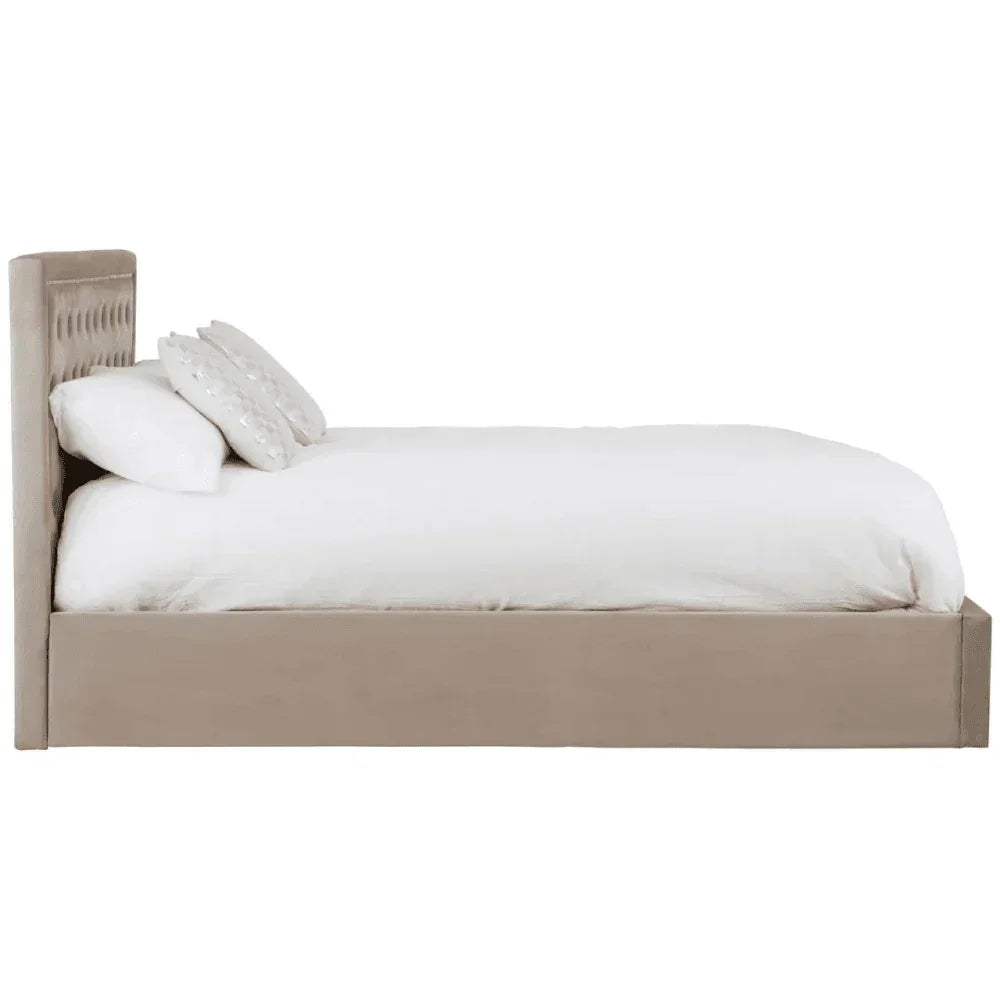 Beige upholstered bed frame with tufted headboard, white bedding and scatter cushions, side view