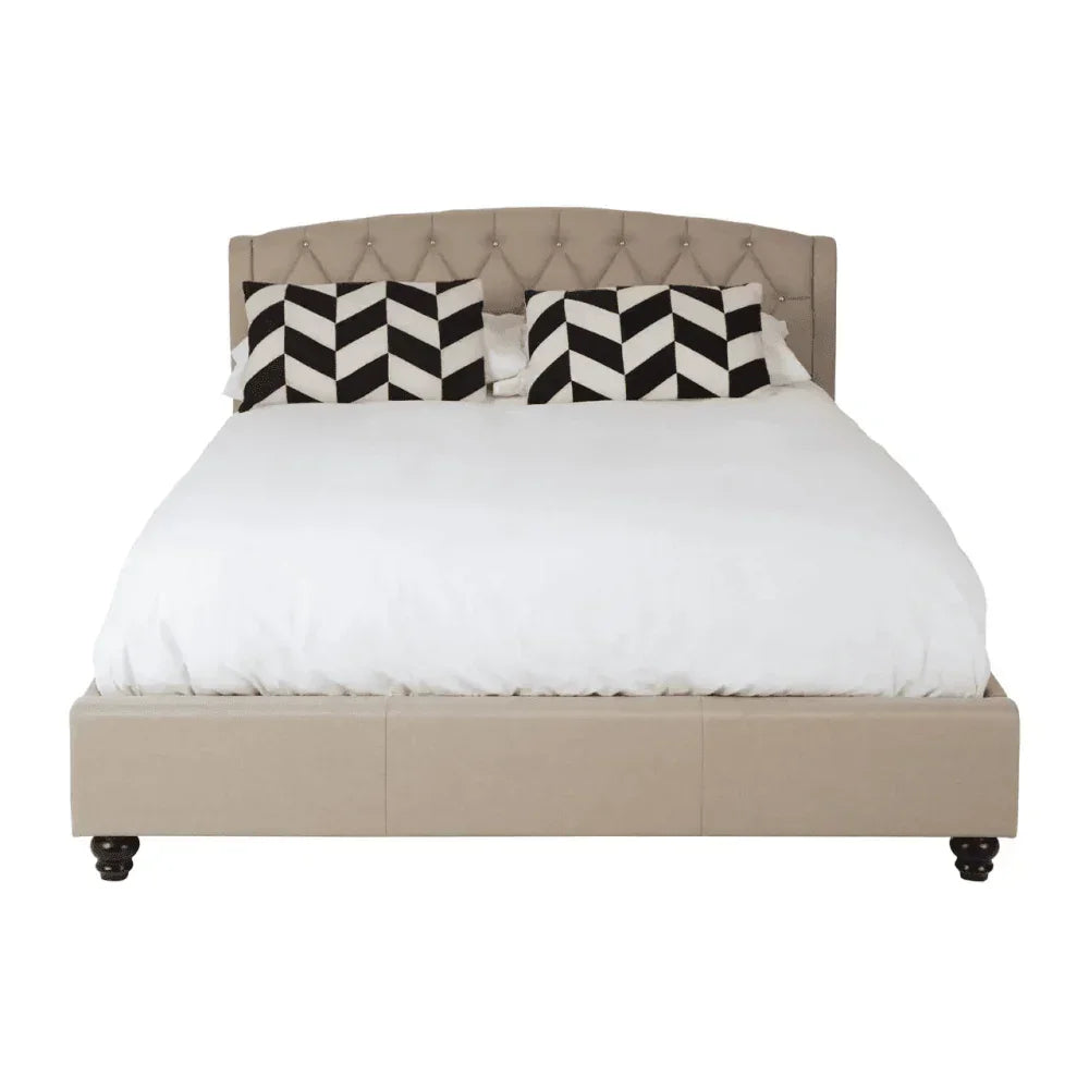 Beige upholstered bed frame with button-tufted headboard and monochrome chevron cushions