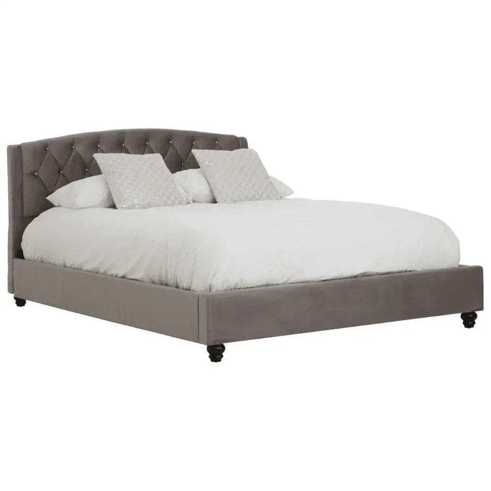 Grey upholstered bed frame with tufted headboard and white bedding