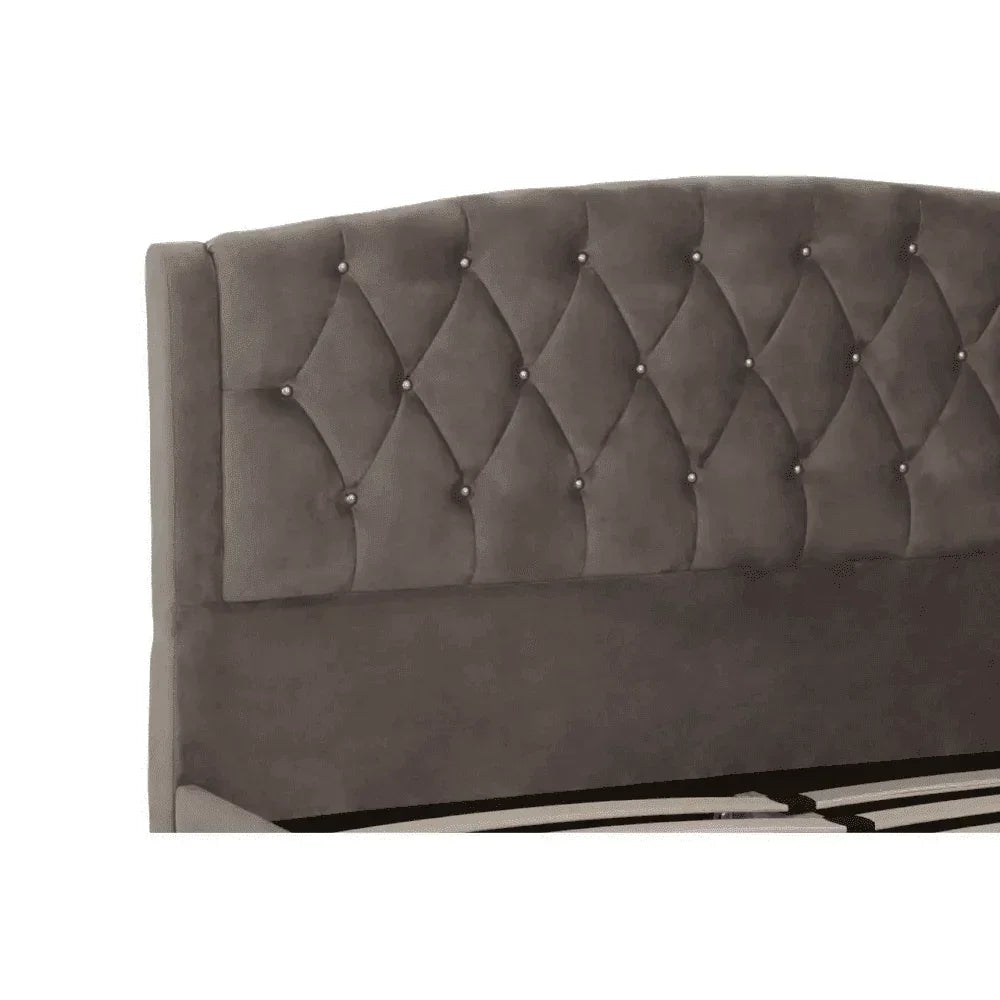 Grey upholstered bed headboard with diamond button tufting detail