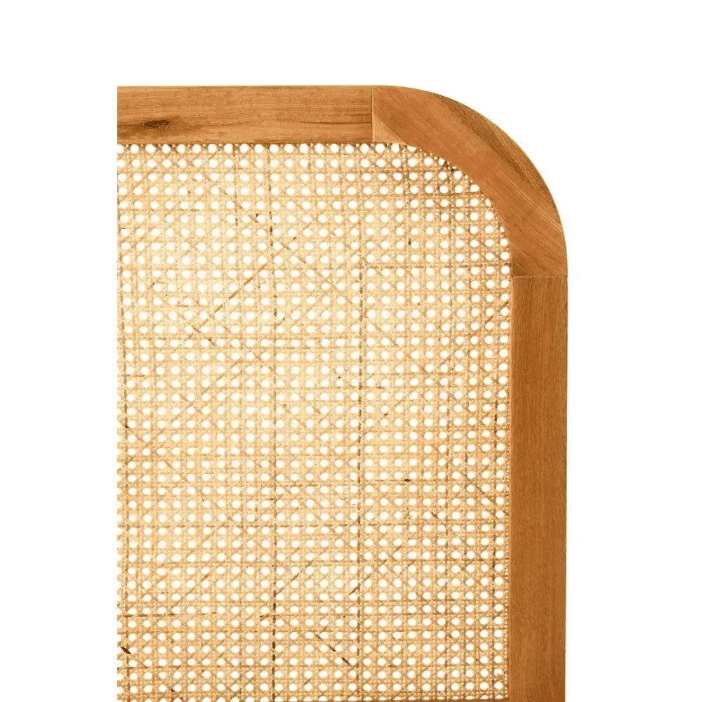Close-up of cane bed headboard with natural wood frame and woven rattan panel
