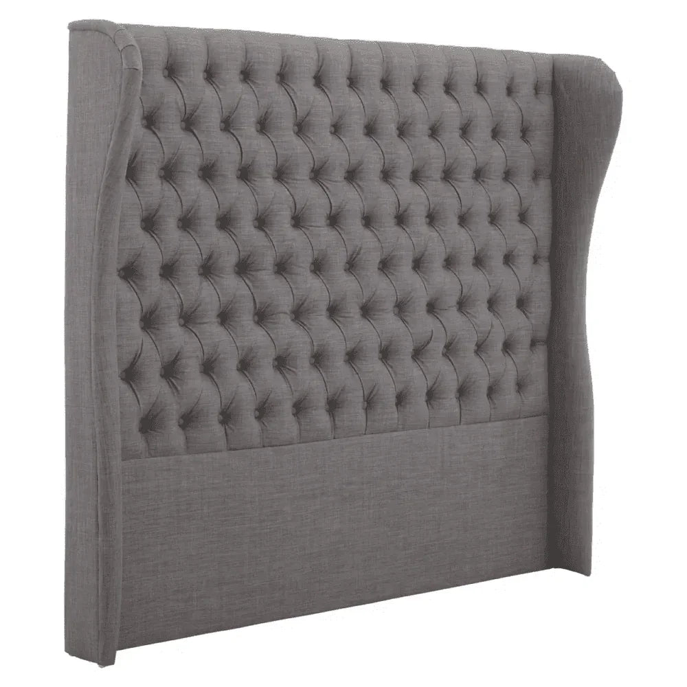 Grey upholstered wingback headboard with deep button tufting, side view angle