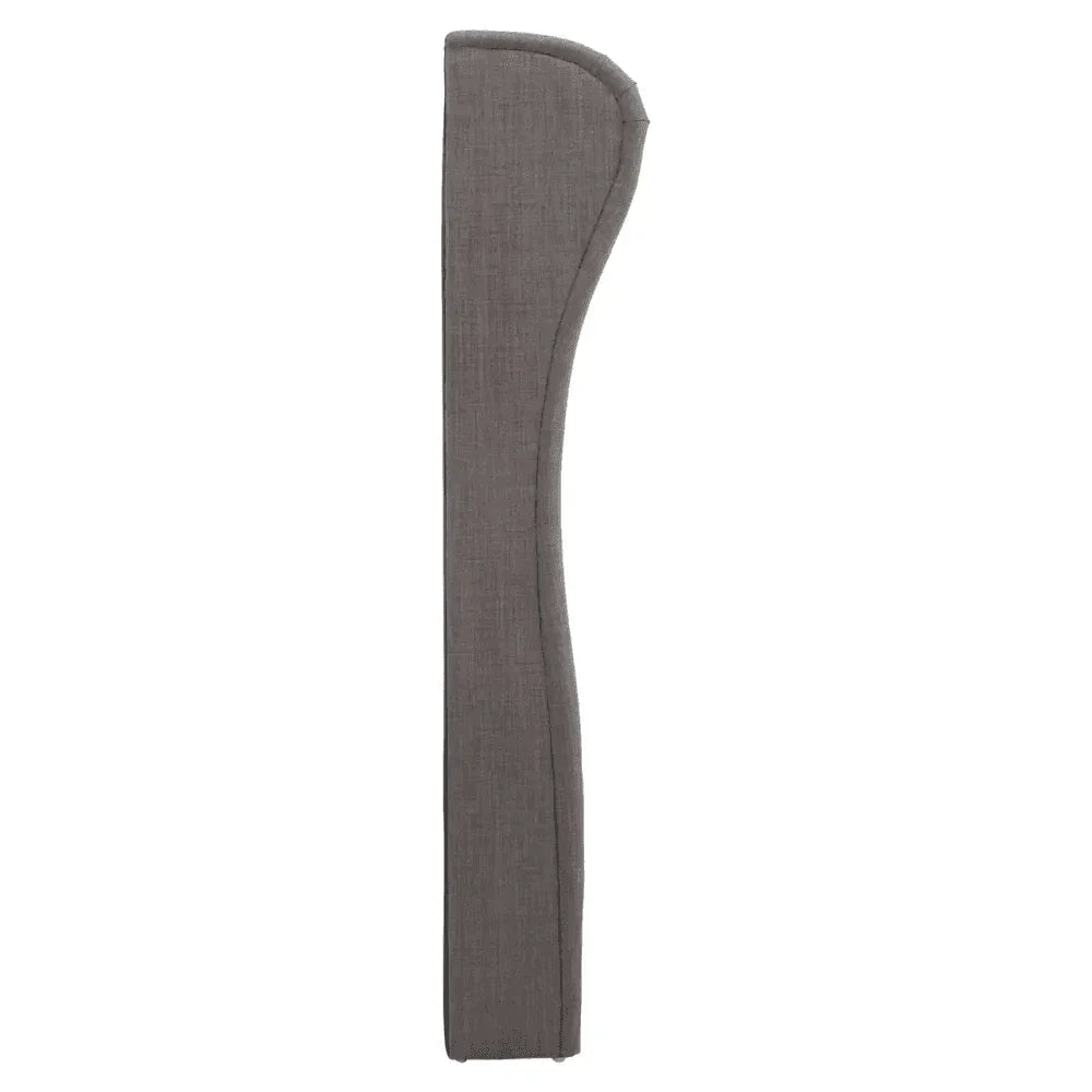 Side view of grey fabric sofa armrest with curved contour