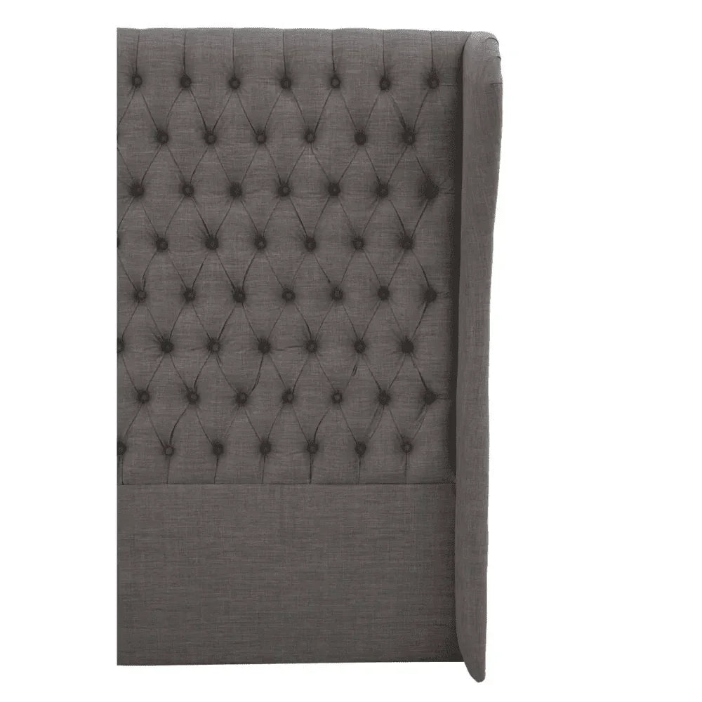 Dark grey fabric bed headboard with button-tufted upholstery and winged side panel