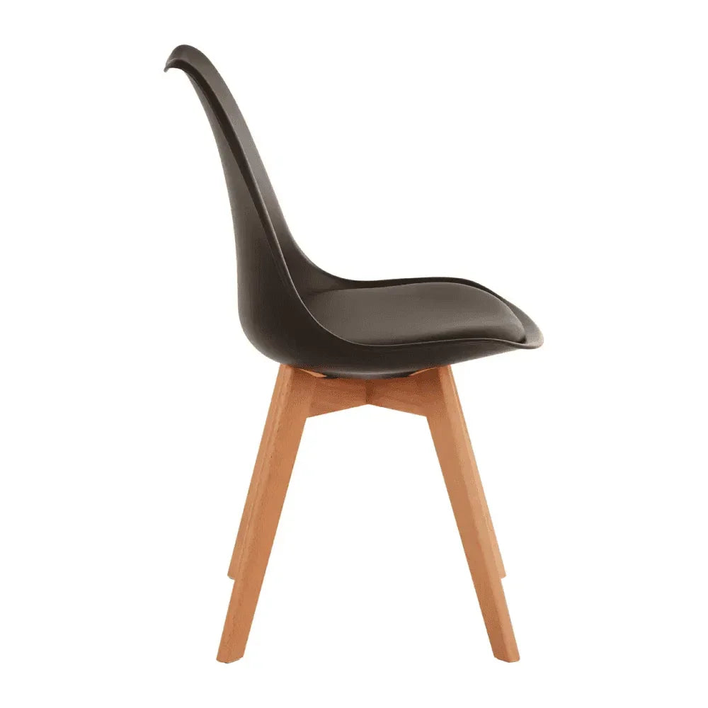 Black dining chair with curved plastic seat and angled wooden legs side view