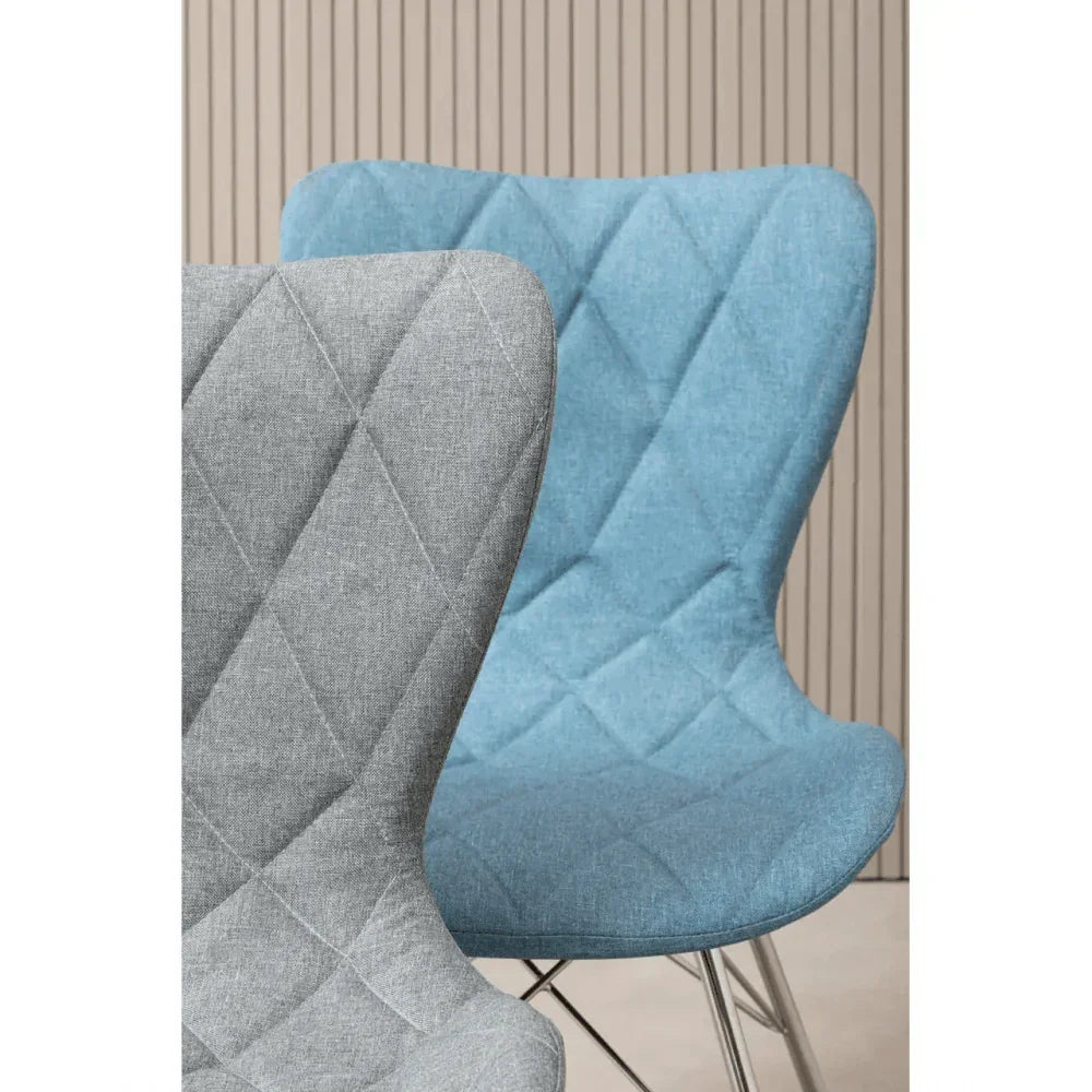 Blue and grey fabric dining chairs with diamond stitching and chrome legs
