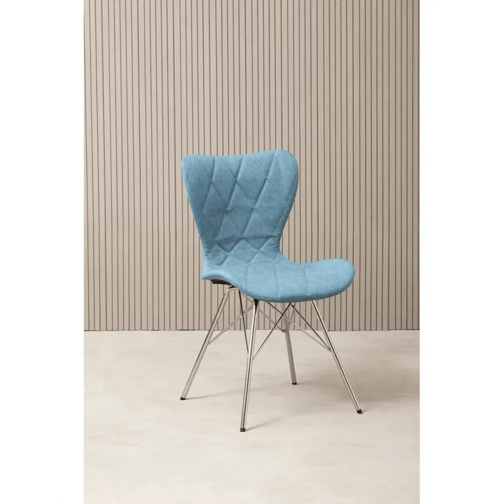 Blue fabric dining chair with metal legs against beige panel background