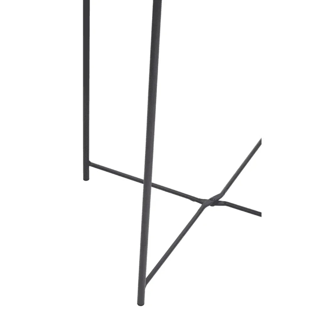 Close view of black metal furniture legs with crossbar support