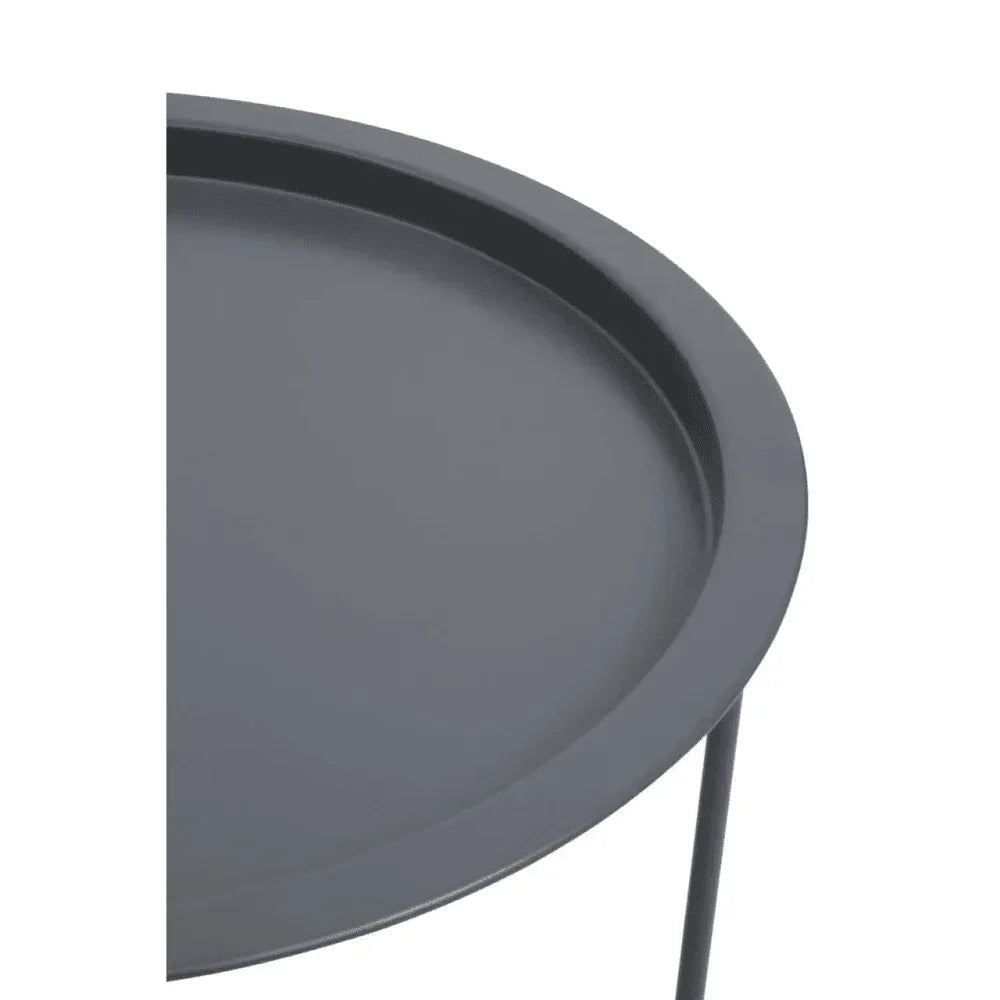 Round black metal side table with raised edge and slim legs, close-up top view