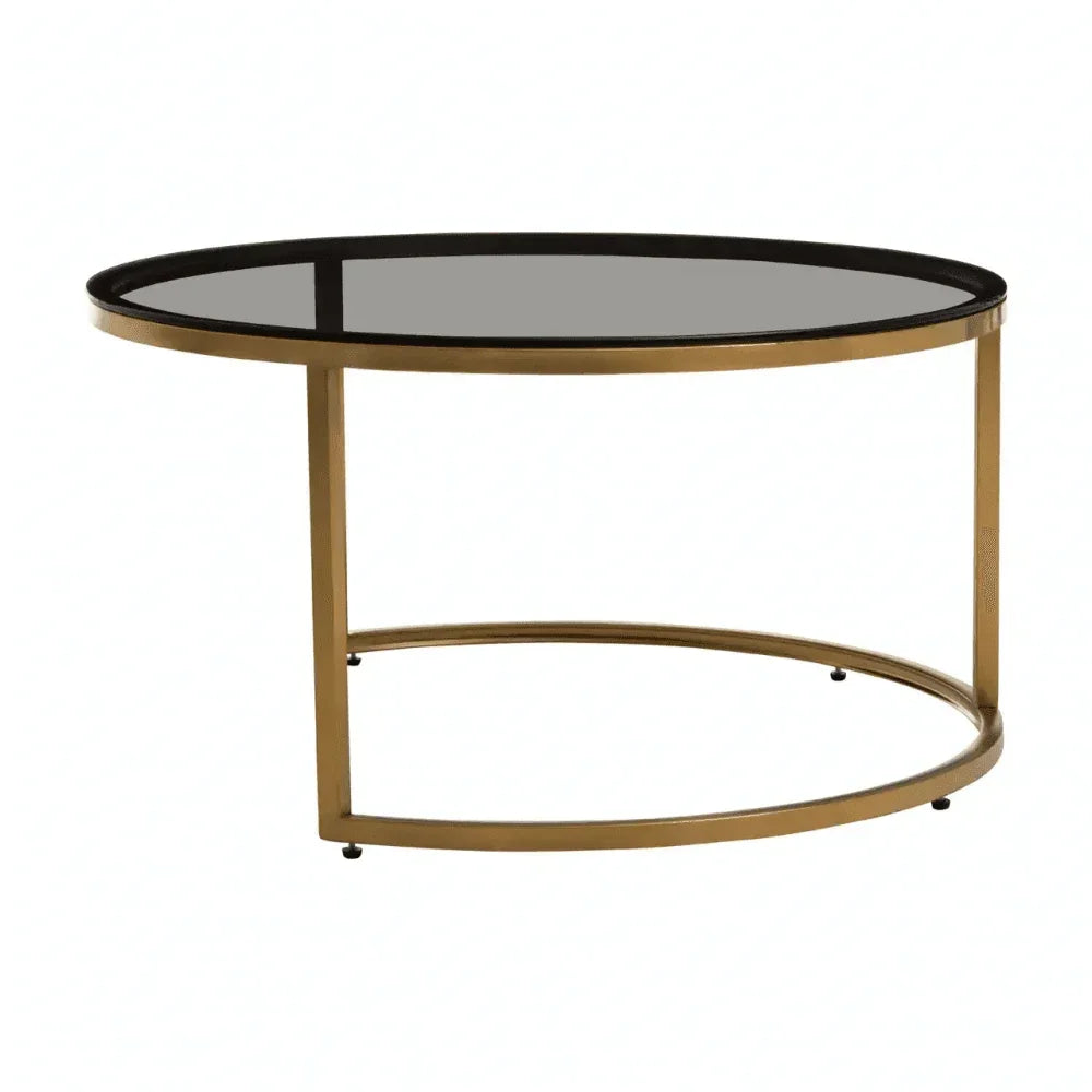 Round glass coffee table with gold metal frame and modern minimalist design