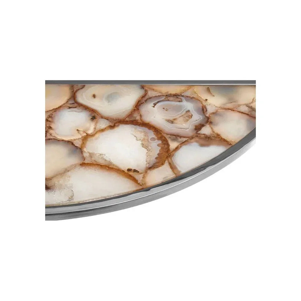Close up of stone top coffee table with beige and brown agate pattern and silver edge