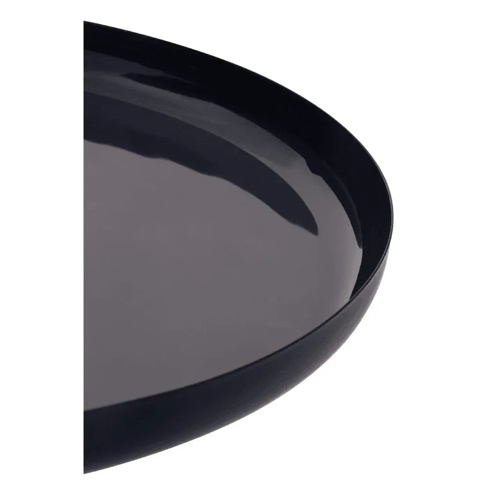 Glossy black tray with raised edge, close-up of smooth surface and rounded rim