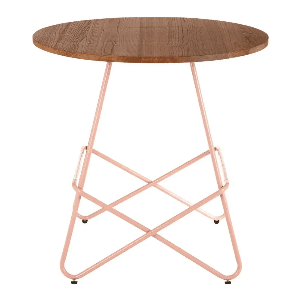 Round wooden side table with light pink metal legs and modern cross base design