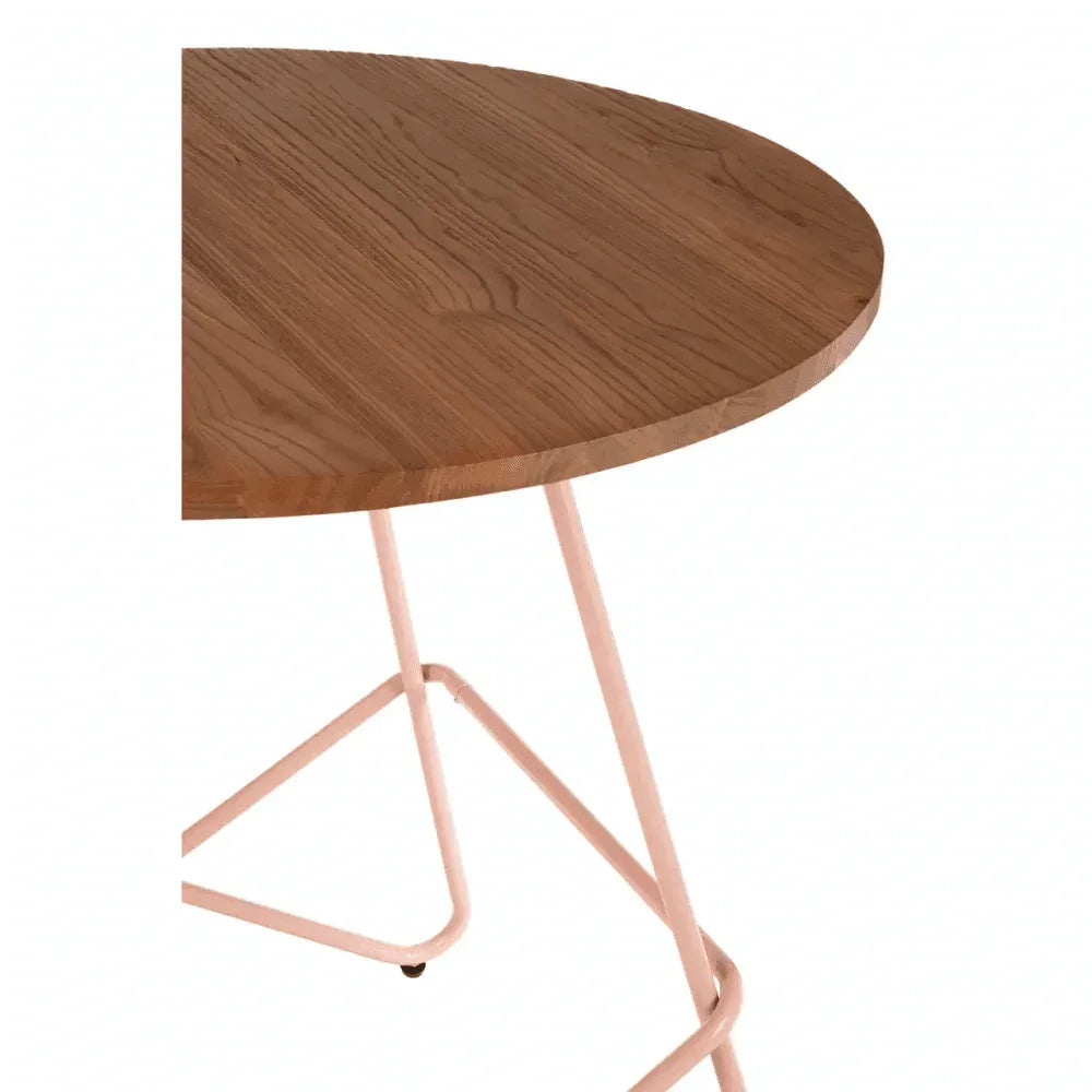 Round wooden dining table with light metal legs, close-up of tabletop and frame