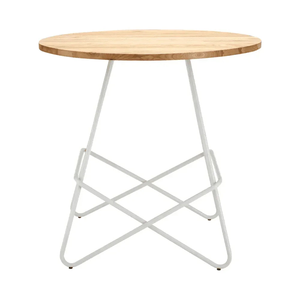 Round wooden dining table with light wood top and white metal cross base