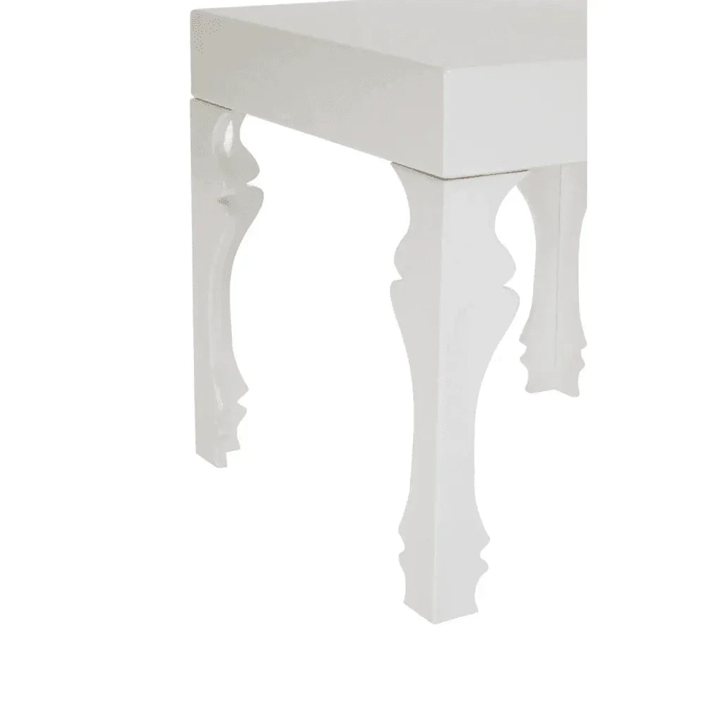 White wooden side table with ornate carved legs, close-up of corner and leg detail