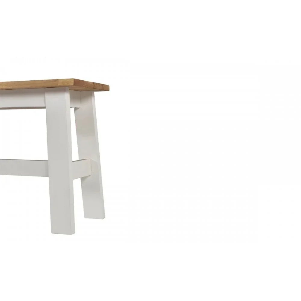 Closeup of white wooden bench legs with natural oak top