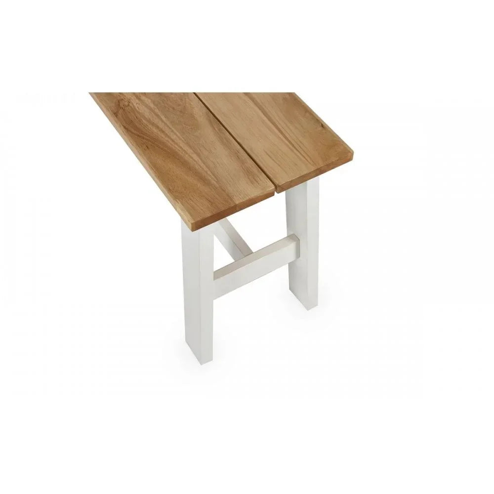 Wood dining bench with white painted legs and natural oak seat, corner angle view