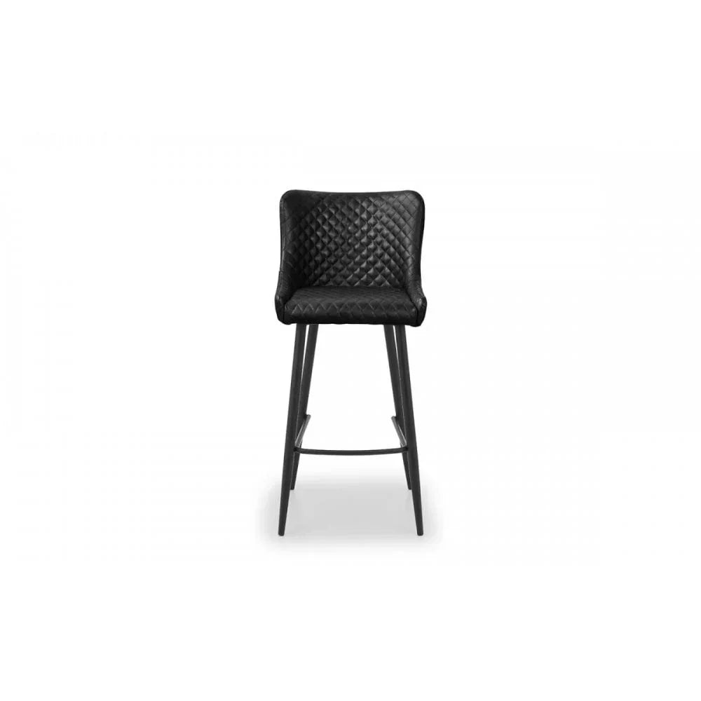 Black bar stool with quilted backrest and seat, elevated legs and footrest, front view