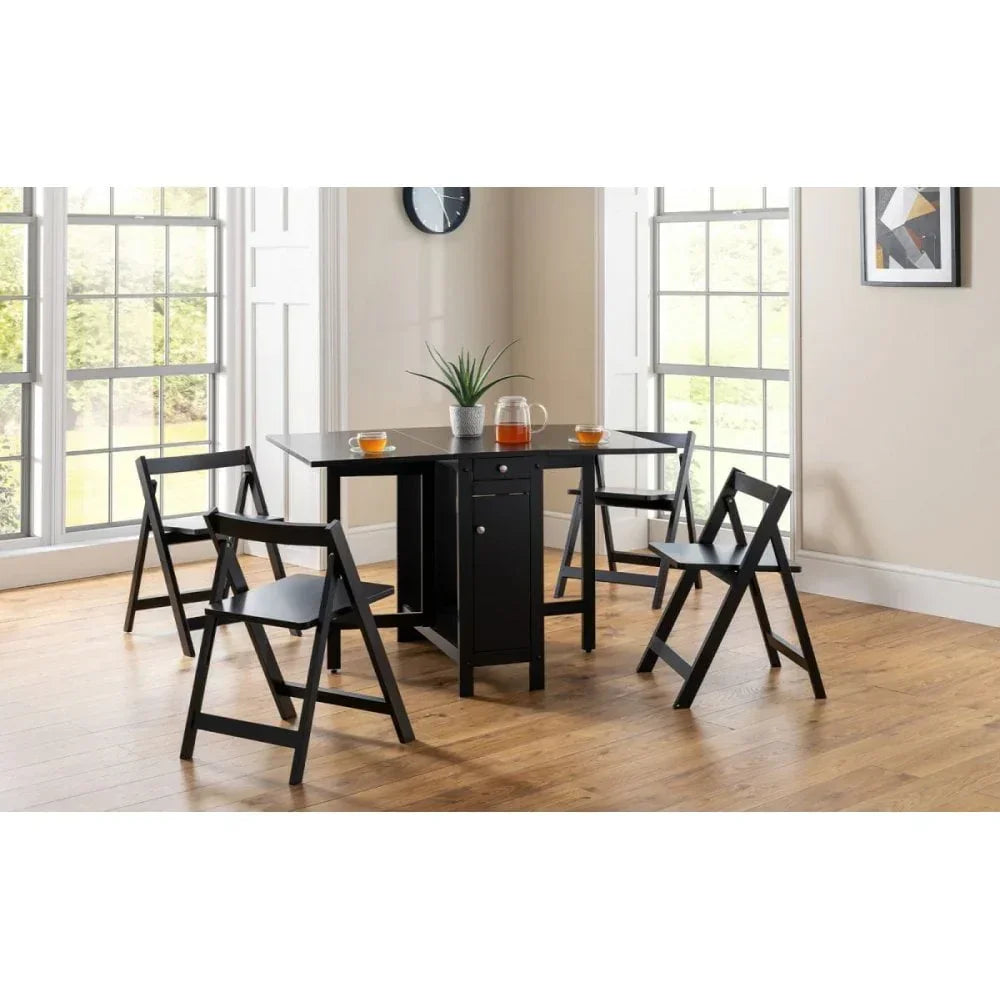 Black folding dining table set with four chairs in bright modern dining room