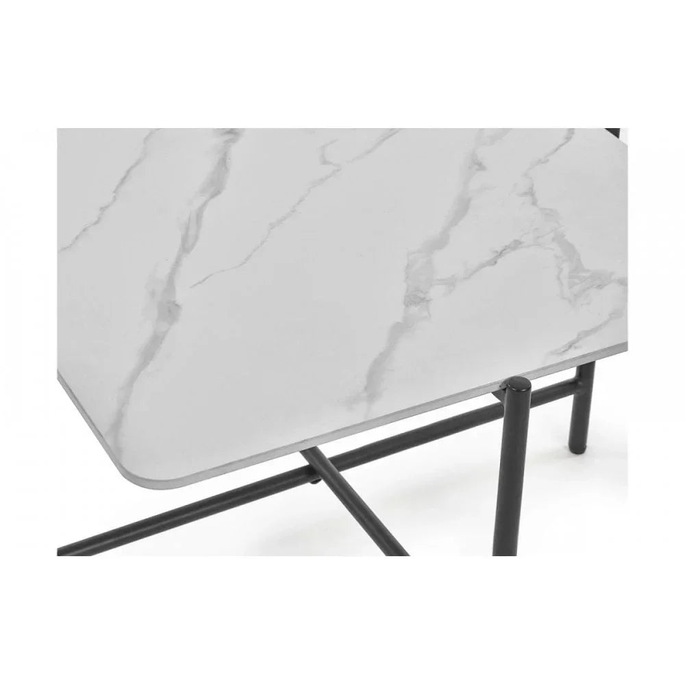 Rectangular marble effect dining table with black metal legs, corner detail view