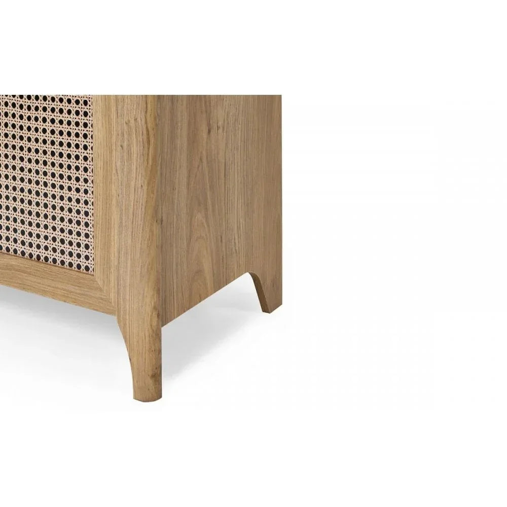 Corner view of oak sideboard with woven rattan panel and curved wood leg