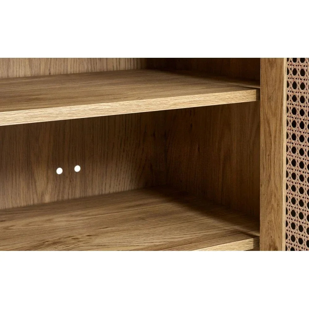 Close-up of wooden shelving unit with adjustable shelf and rattan panel detail