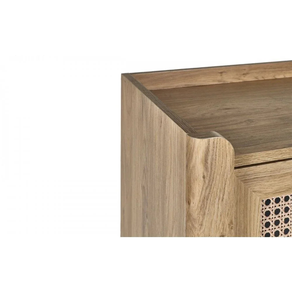 Close-up of wooden cabinet corner with natural finish and rattan door panel