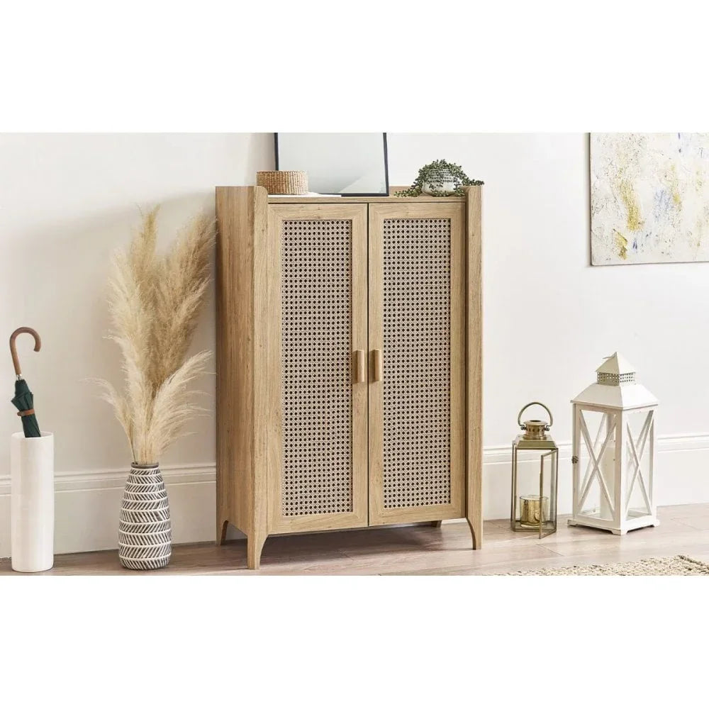 Wooden rattan cabinet with double doors in modern hallway, surrounded by decor accents