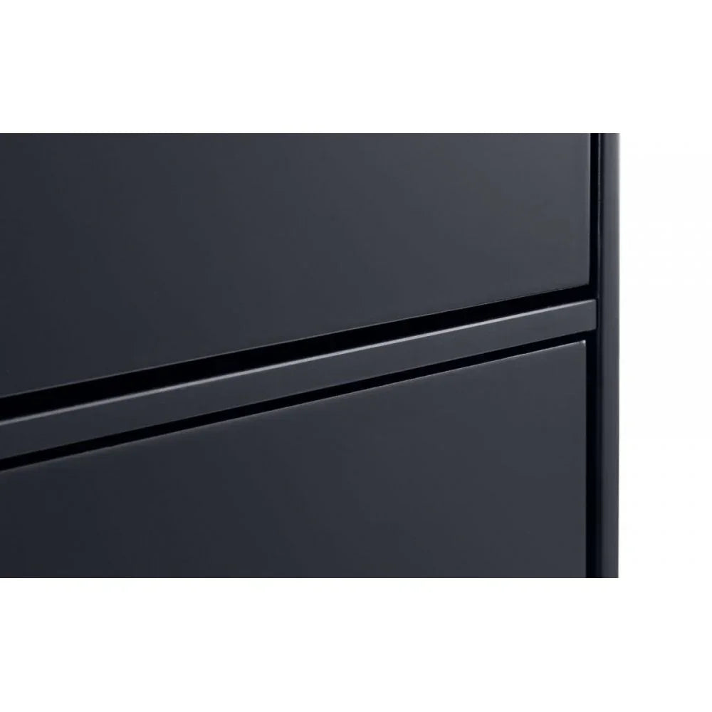 Closeup of black chest of drawers with smooth modern finish and handleless design