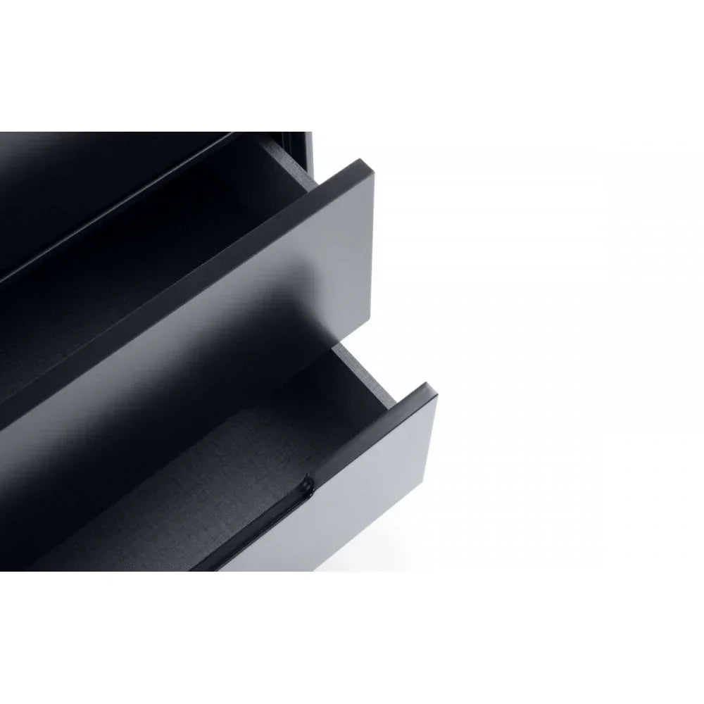 Close up of black chest of drawers with two open drawers showing interior space