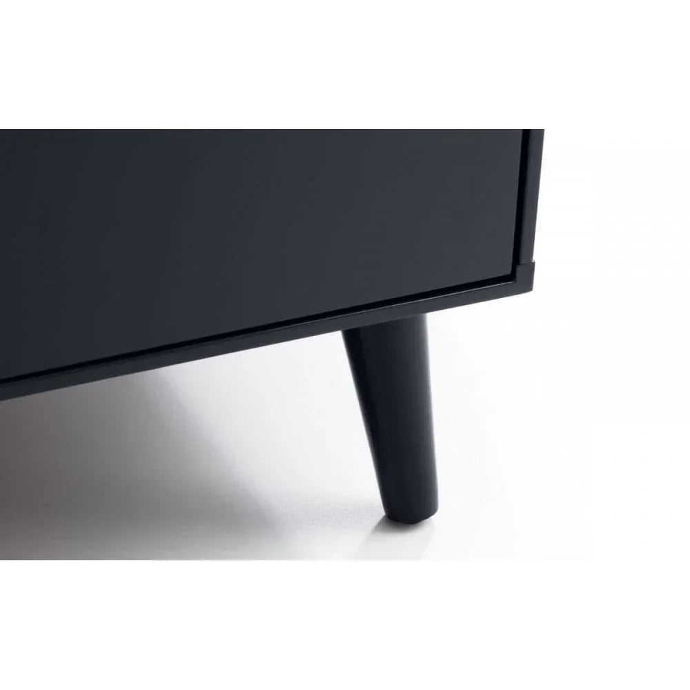Black wooden furniture leg with tapered design on smooth white floor