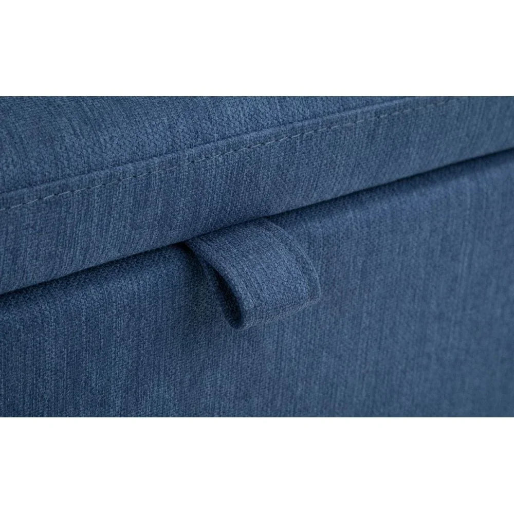 Closeup of blue fabric storage ottoman with stitched handle detail