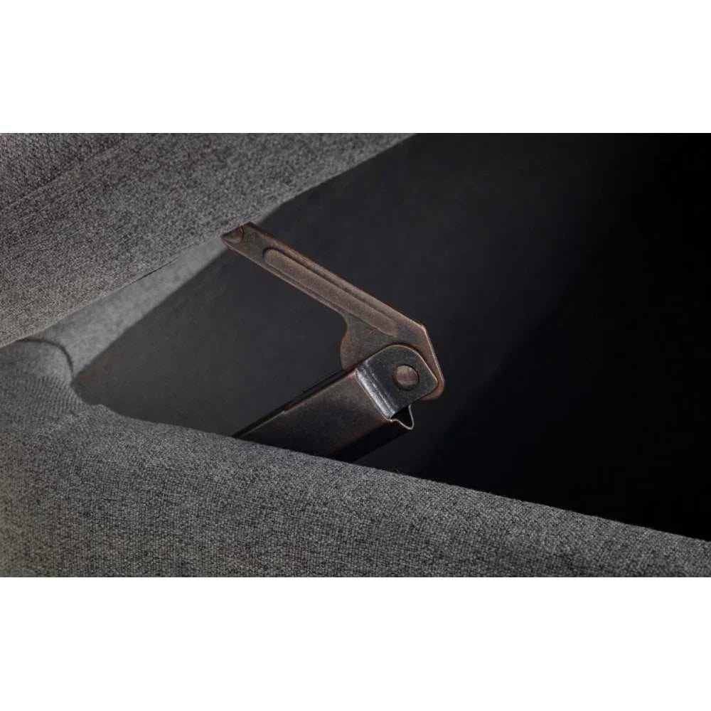 Closeup of grey fabric ottoman bed hydraulic lift mechanism